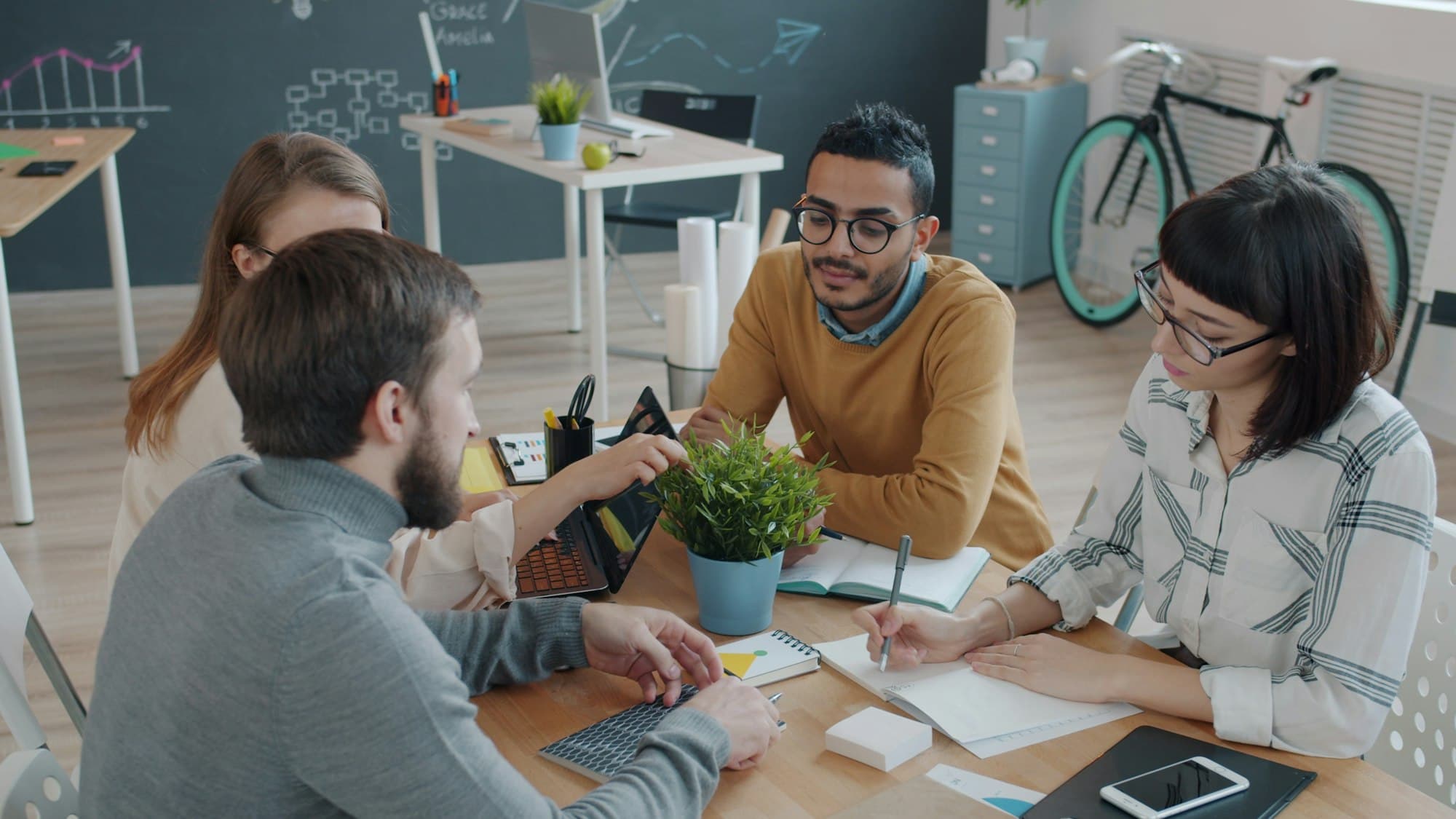 A diverse team collaborating around a table in a modern office